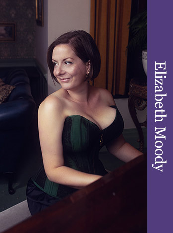 This photo shows Elizabeth Moody sitting at a piano in an elegantly furnished room, looking to the left, wearing a green and black striped corset. Beth's shoulders are bare and Beth is smiling. There is a purple coloured vertical graphical bar to the right of the photo, with the text